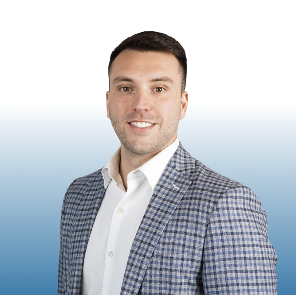 Equity team member headshot in a plaid blazer and white shirt